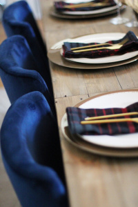 Table setting ideas. Gold flatware. plaid napkins. gold chargers. rustic table. gold accents. Blue velvet chairs