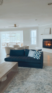coastal living room with fireplace, blue sofa in living room, coastal home decor