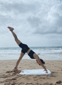 beach workout: downward dog to pigeon plank