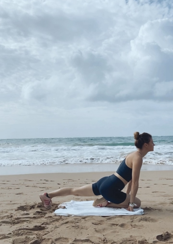 beach workout: downward dog to pigeon plank