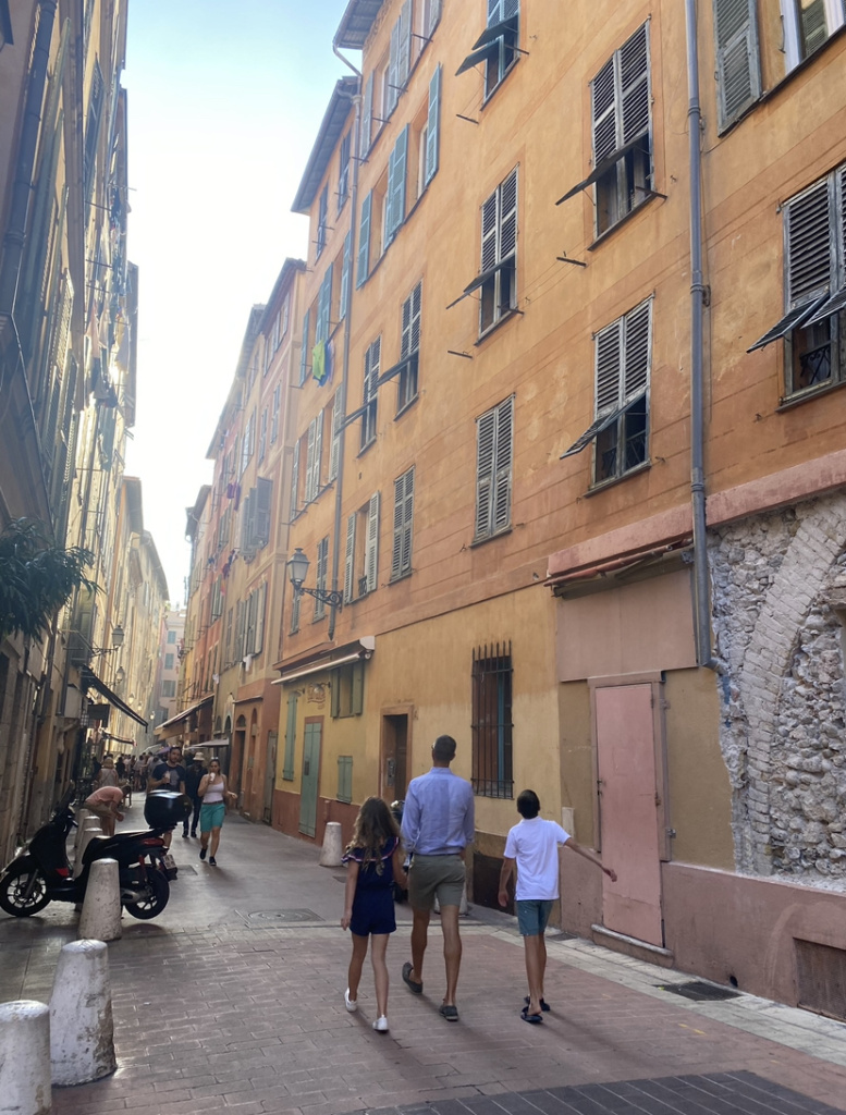 streets of old town nice, man and kids on vacation in nice, France